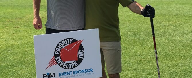 Two men smiling on a golf course next to priority envelop sign - mailing envelopes