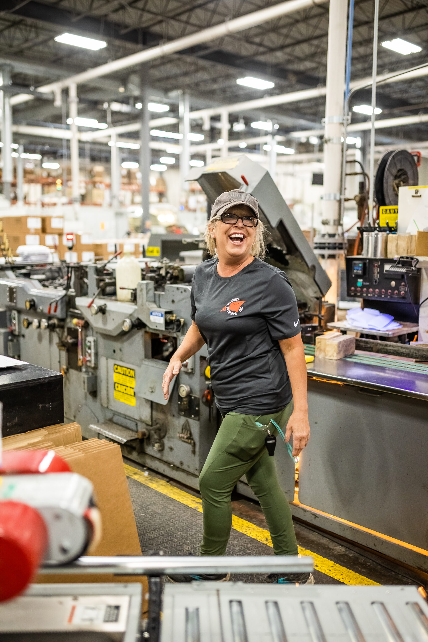 woman laughing in warehouse - folding cartons