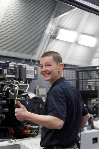 A person smiling and giving a thumbs up in a warehouse - wholesale packaging